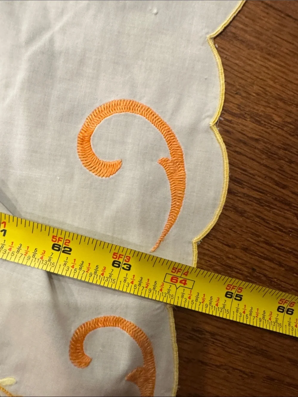 White vintage Tablecloth W/ Orange & Yellow Floral  Design. Size 114x64